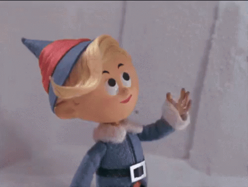 A Cartoon Elf Is Waving His Hand In The Air . GIF