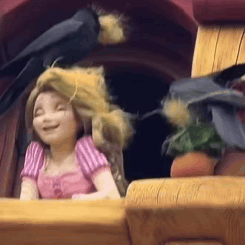 a cartoon girl is sitting in a window with a bird flying around her head .