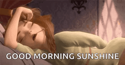A Cartoon Girl Is Sleeping On A Bed With The Words `` Good Morning Sunshine '' Written Above Her . GIF