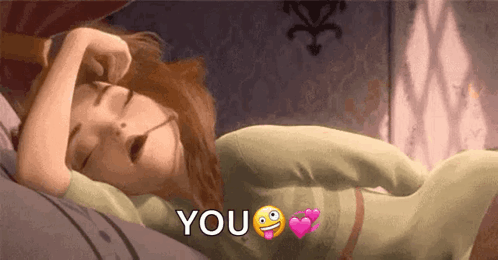 A Cartoon Girl Is Sleeping On A Bed With The Words `` You '' Written On It . GIF
