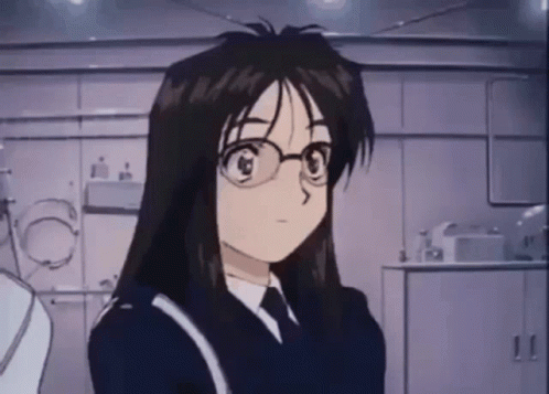 A Cartoon Girl With Long Hair And Glasses Is Standing In A Room . GIF