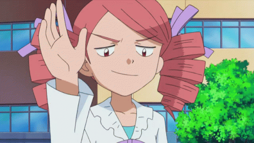 A Cartoon Girl With Red Hair And Purple Ribbons In Her Hair Is Waving Her Hand GIF