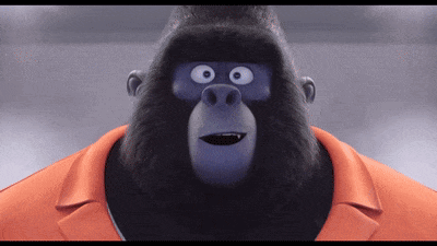 A Cartoon Gorilla Wearing An Orange Collared Shirt GIF
