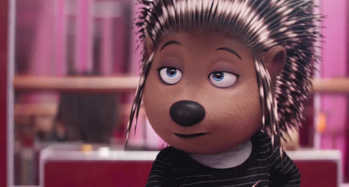 A Cartoon Hedgehog Wearing A Black And White Striped Shirt Is Looking At The Camera GIF