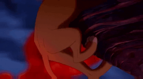 A Cartoon Lion Is Standing On A Rock In Front Of A Fire Background GIF