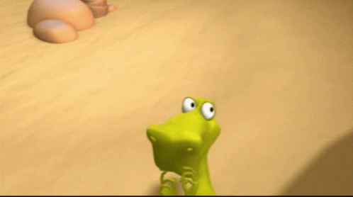 A Cartoon Lizard With A Big Mouth Is Standing On A Sandy Surface GIF