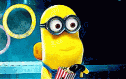 Cartoon Minion Holding Popcorn And Microphone GIF