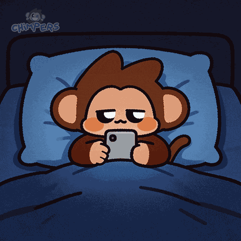 A Cartoon Monkey Is Laying In A Bed Looking At A Cell Phone GIF