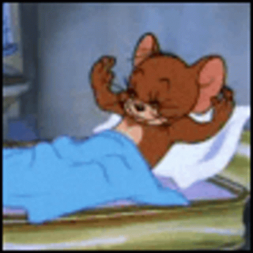 A Cartoon Mouse Is Laying In A Bed With A Blue Blanket On It . GIF