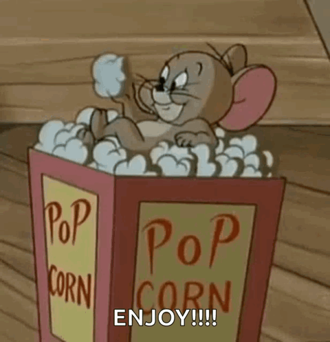 a cartoon mouse is sitting in a bucket of popcorn and says `` enjoy '' .