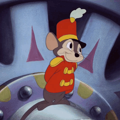 A Cartoon Mouse Wearing A Red And Yellow Uniform And A Hat GIF