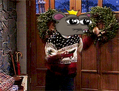 A Cartoon Mouse With A Crown On Its Head Is Holding A Wreath In Front Of A Door GIF