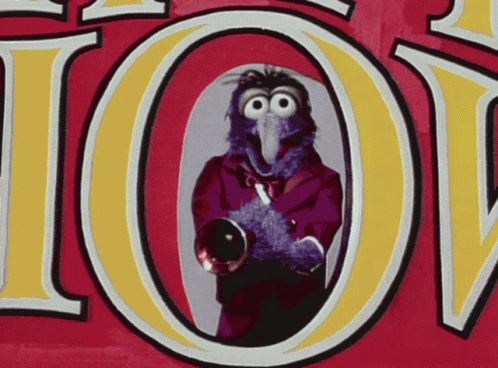 A Cartoon Of A Bird Holding A Trumpet In Front Of A Sign That Says Ioy GIF