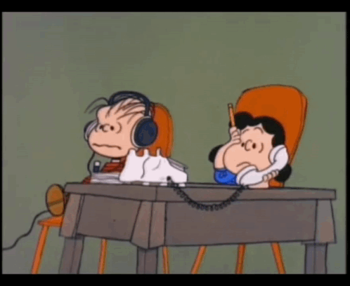 A Cartoon Of A Boy And A Girl Sitting At A Desk Talking On A Phone GIF