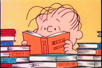 A Cartoon Of A Boy Reading A Book In Front Of A Stack Of Books . GIF