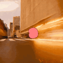 A Cartoon Of A Bubble Gum Character Is Driving Down A Street GIF