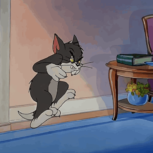A Cartoon Of A Cat Standing Next To A Table With A Book On It GIF