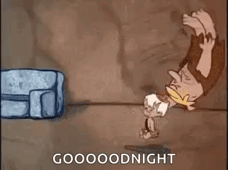 A Cartoon Of A Caveman Standing On His Head Next To A Bag And A Couch . GIF