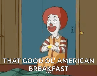 A Cartoon Of A Clown Holding A Mcdonald 'S Sign And Saying `` That Good Ol ' American Breakfast `` . GIF