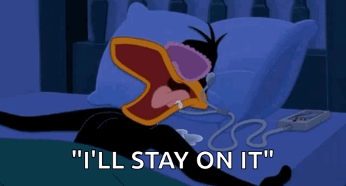 A Cartoon Of A Duck Laying On A Bed With The Words " I 'Ll Stay On It " Below Him GIF