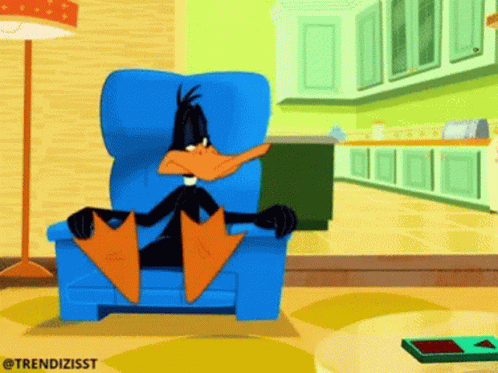 A Cartoon Of A Duck Sitting In A Chair GIF