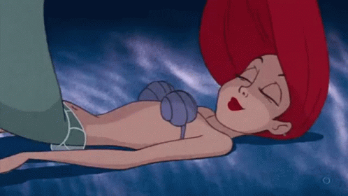 A Cartoon Of A Little Mermaid Sleeping On The Ground GIF