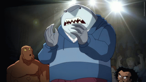 A Cartoon Of A Man Dressed As A Shark Standing In Front Of A Crowd GIF