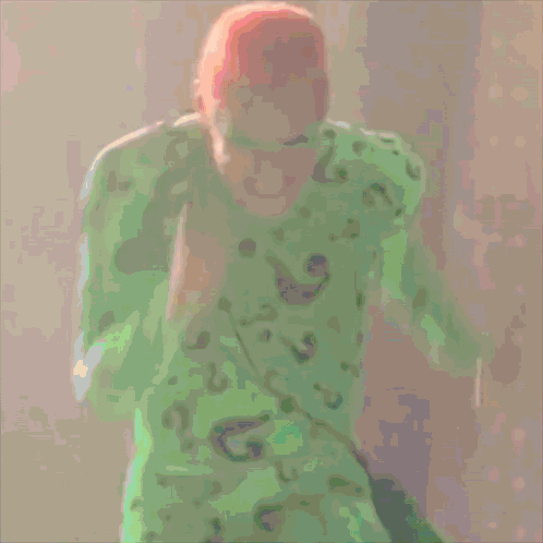 A Cartoon Of A Man In A Green Shirt And Green Mask GIF
