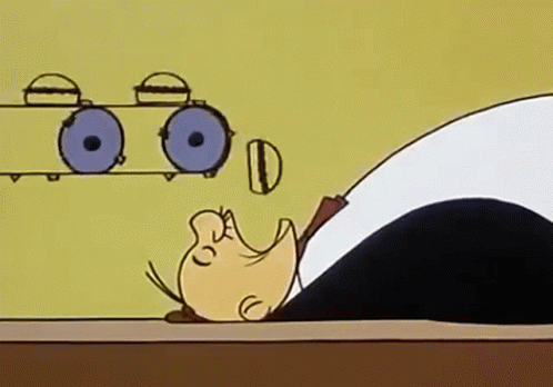 A Cartoon Of A Man Laying On A Table With His Head On A Table . GIF
