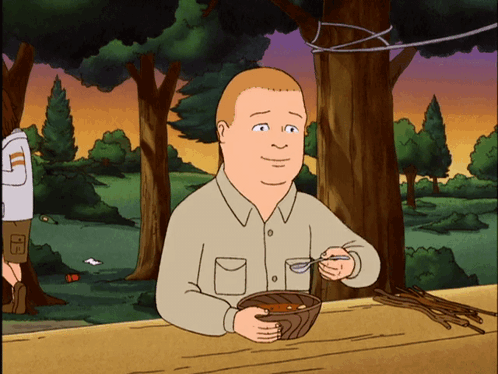 A Cartoon Of A Man Sitting At A Table Eating A Bowl Of Food GIF