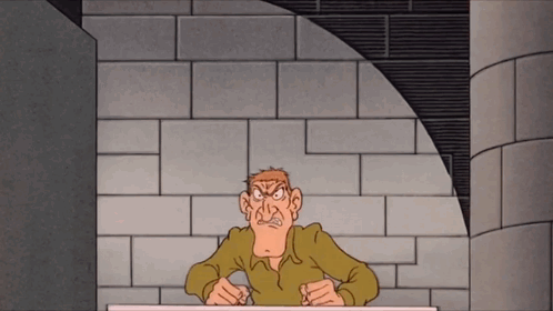 A Cartoon Of A Man Sitting At A Table With A Brick Wall Behind Him GIF