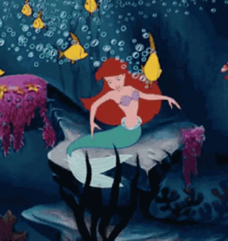 A Cartoon Of A Mermaid In The Ocean GIF