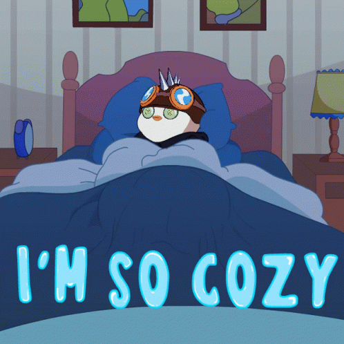A Cartoon Of A Penguin Laying In A Bed With The Words I 'M So Cozy Below It GIF