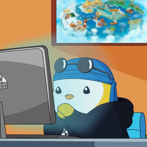 A Cartoon Of A Penguin Sitting In Front Of A Computer Monitor GIF