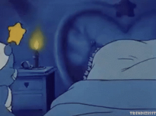 a cartoon of a smurf sleeping in a bed with a star on his head