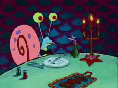 A Cartoon Of A Snail Sitting At A Table With A Plate Of Food On It GIF