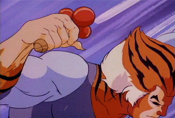 A Cartoon Of A Tiger Holding A Red Object In His Hand GIF