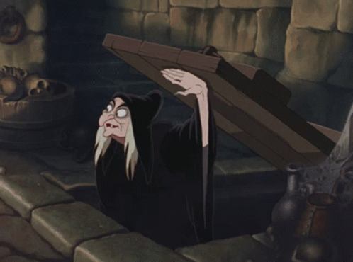 A Cartoon Of A Witch Holding A Wooden Plank GIF