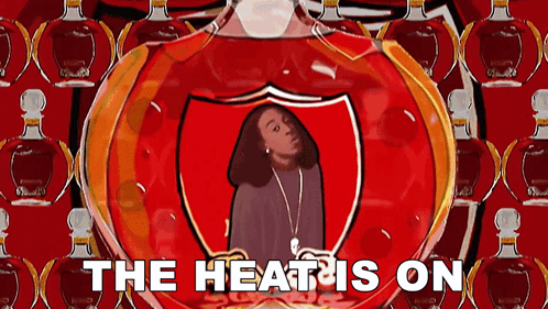 a cartoon of a woman in a shield with the words the heat is on below her