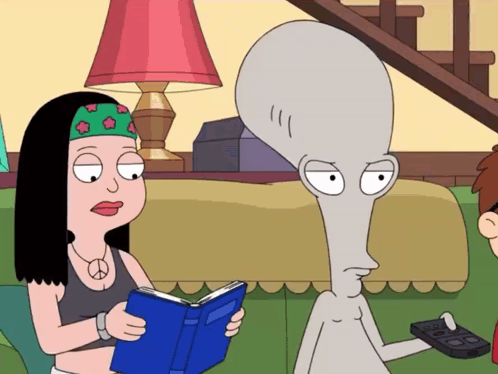 Woman Reading Book Next To Grey Alien GIF