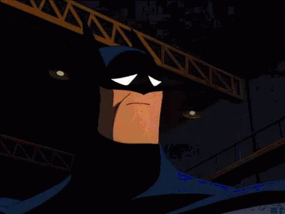 A Cartoon Of Batman Making A Sad Face In A Dark Room GIF