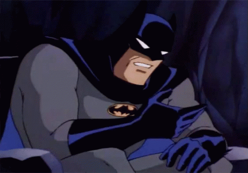A Cartoon Of Batman Reading A Book With A Smile On His Face GIF