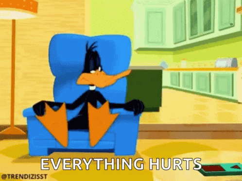 A Cartoon Of Daffy Duck Sitting In A Chair With The Words Everything Hurts Written Below Him . GIF