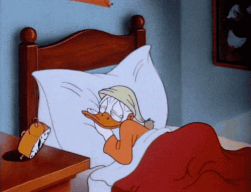 A Cartoon Of Donald Duck Is Sleeping In A Bed GIF