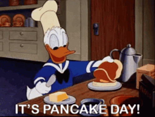 A Cartoon Of Donald Duck Preparing Pancakes With The Words It 'S Pancake Day Below Him GIF