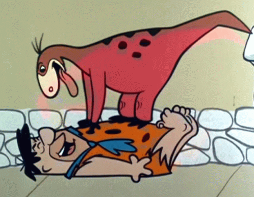 A Cartoon Of Flintstone Laying On The Ground With A Dinosaur On His Back GIF