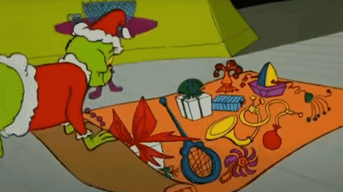 A Cartoon Of Grinch Laying On A Rug With Toys On It GIF