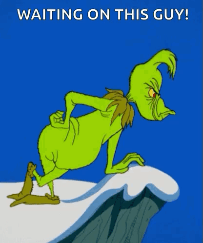 A Cartoon Of Grinch Standing On A Cliff With The Words " Waiting On This Guy " Below Him GIF