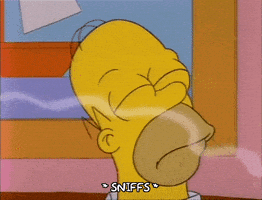 A Cartoon Of Homer Simpson Sniffing Something With His Mouth Open GIF