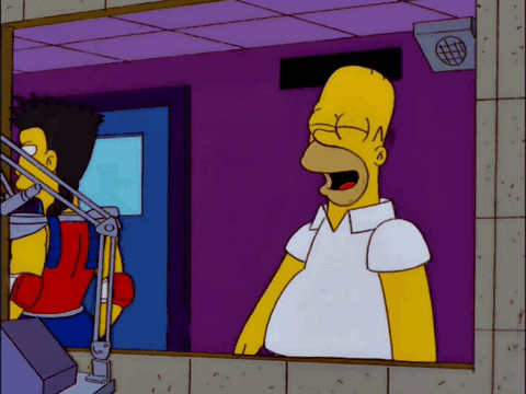 A Cartoon Of Homer Simpson Standing In Front Of A Microphone With His Mouth Open GIF